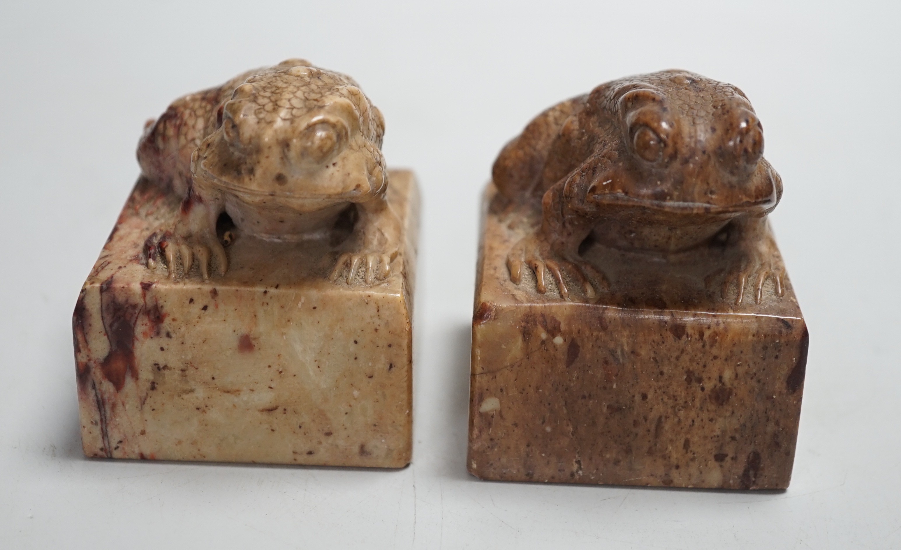 A pair of Chinese carved soapstone chop seals decorated as seated toads, 6cm